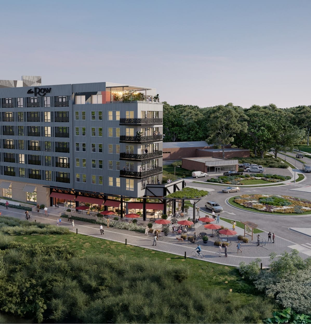 Arial view of the Row with bottom level shops, outdoor seating, lit up walk paths and a roundabout driveway