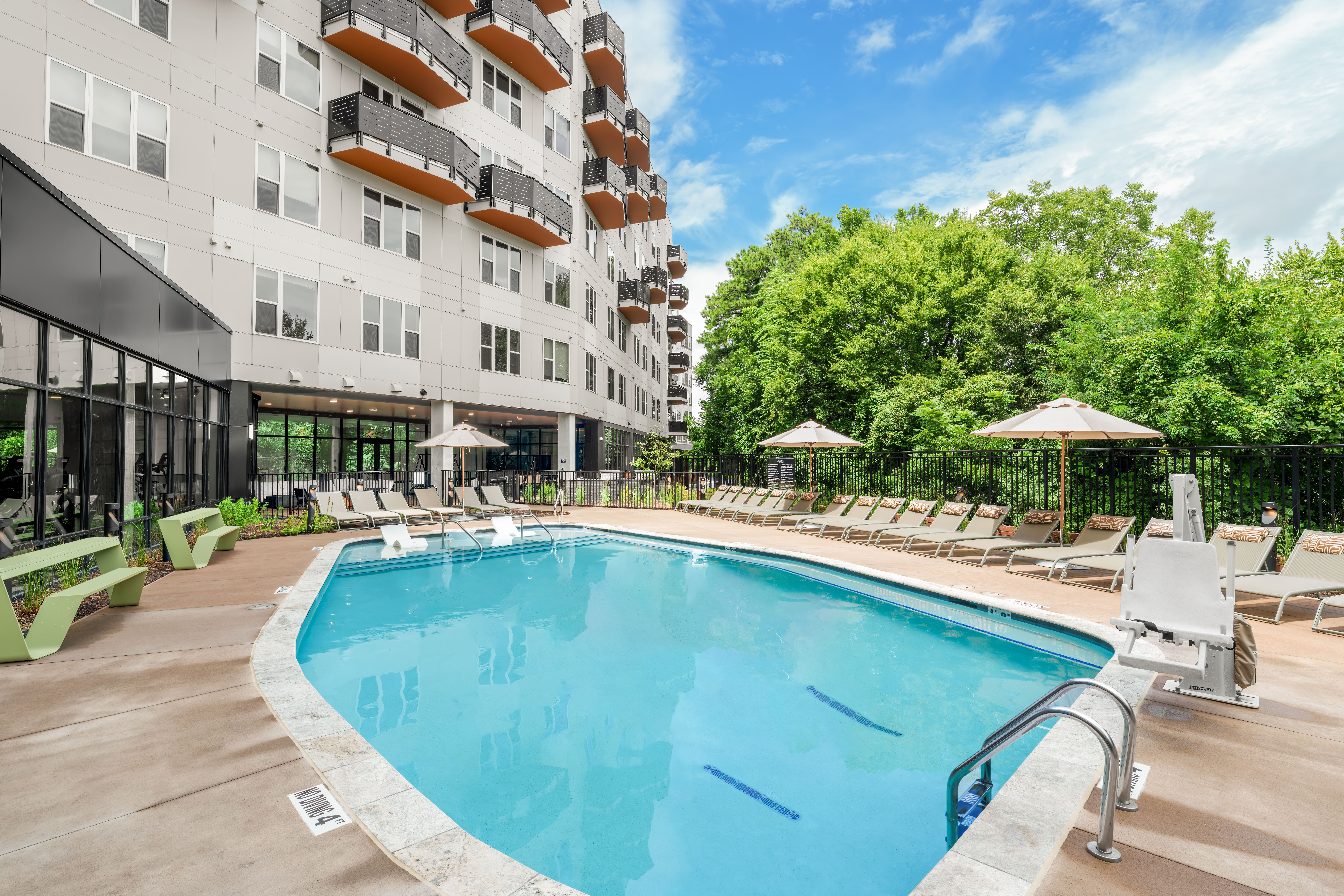 Resort-style swimming pool with sundeck at The Row apartments in Raleigh NC